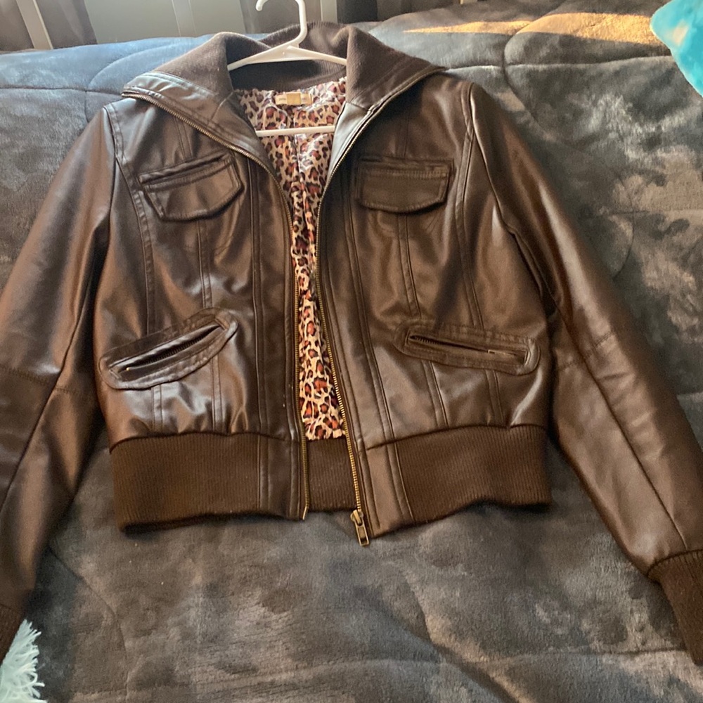 A cute brown leather jacket with little wear.